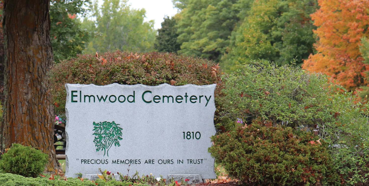 Image of the entrance sign to Elmwood cemetery with the text 'precious memories are ours in trust'